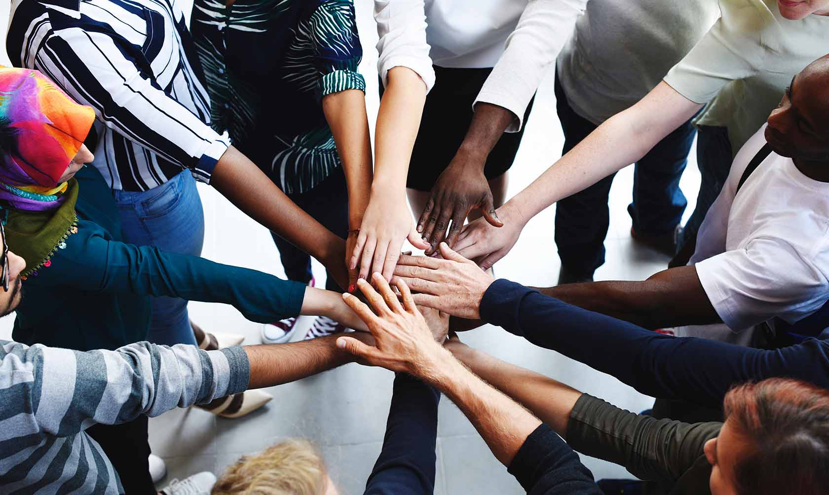 A group of people putting their hands together