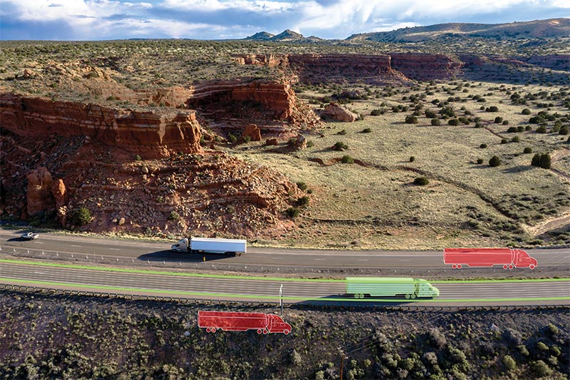 A semi truck experiences spoofing while navigating on a desert road.