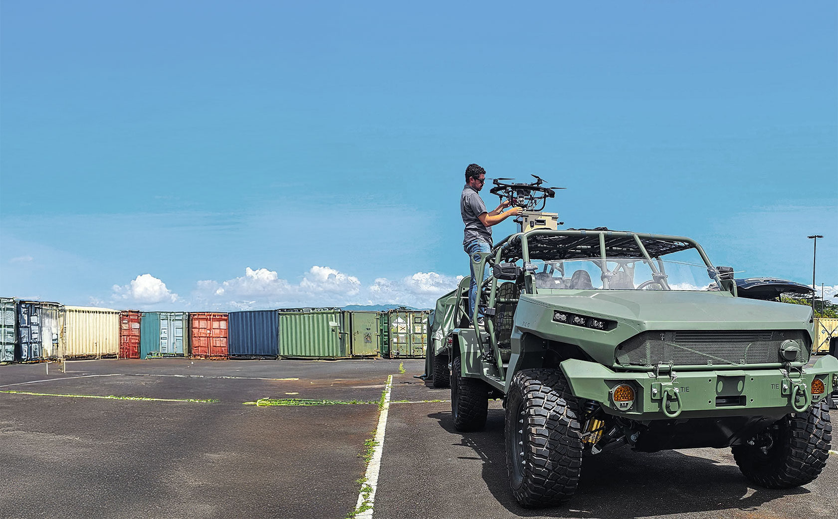 Man setting up Hoverfly tethered unmanned aerial system (TeUAS) on an off-road vehicle.